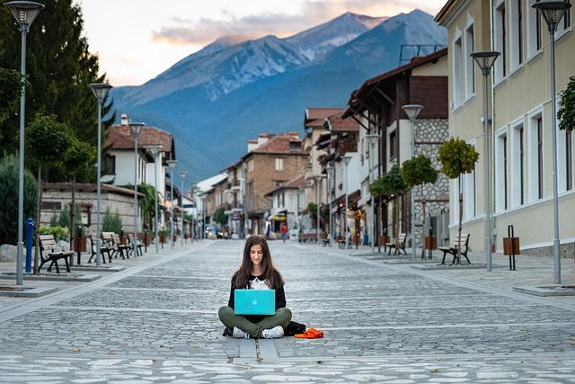 Woman working on a laptop with coffee
